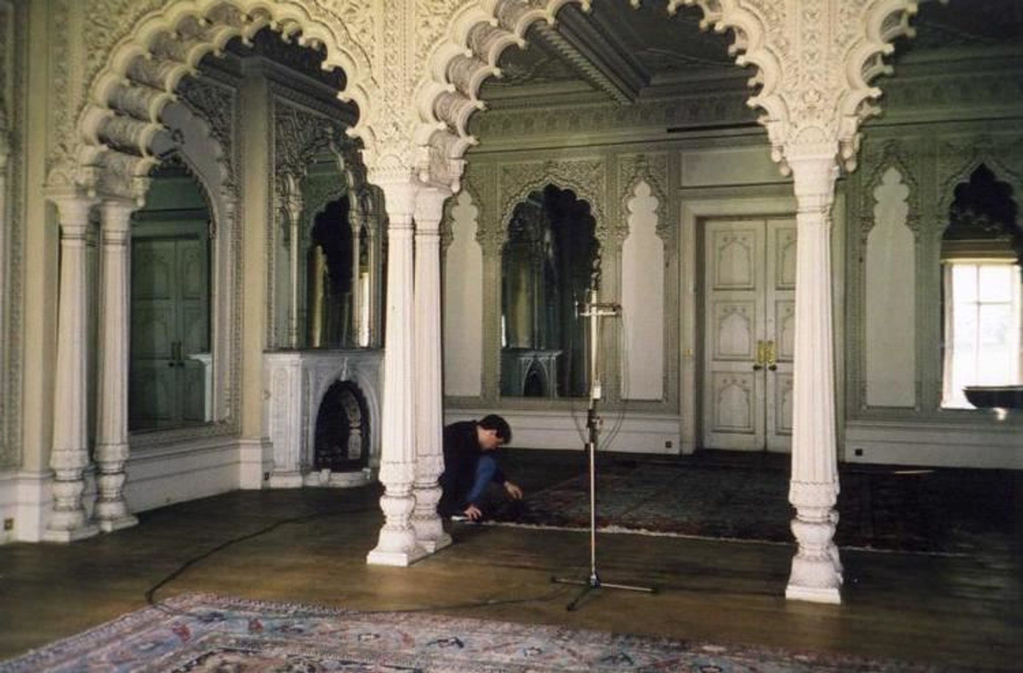 Image of a person recording sounds in a decorated room inside a castle. Elveden Hall, Suffolk, England. 